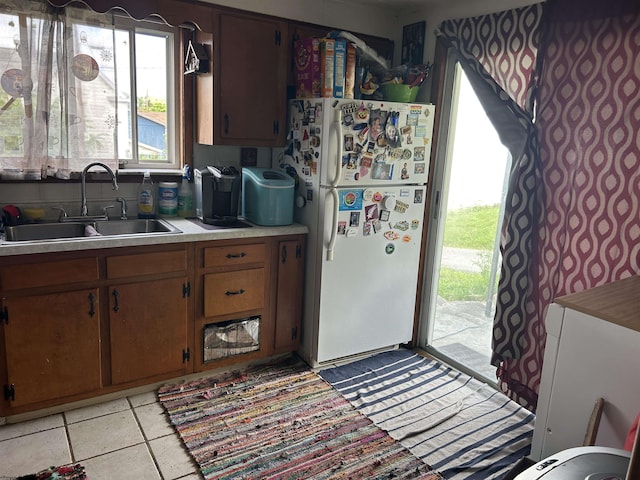 374 Dunkard Ave, Morgantown, WV 26501 - kitchen with freestanding refrigerator, light countertops, and brown cabinetry