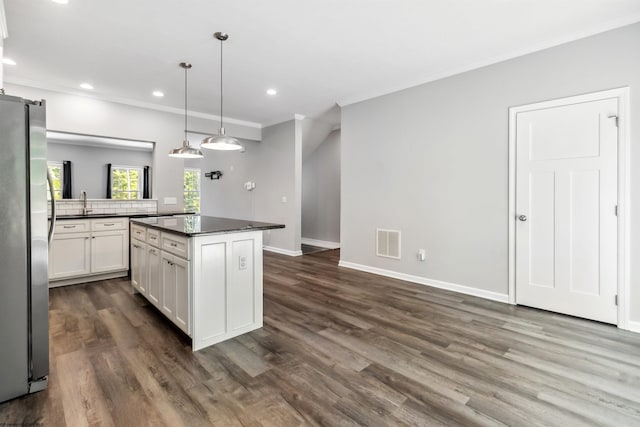26 Misty Ln, Fairmont, WV 26554 - kitchen featuring freestanding refrigerator, dark countertops, ornamental molding, white cabinets, and a kitchen island