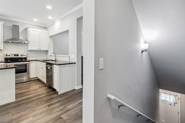 26 Misty Ln, Fairmont, WV 26554 - kitchen featuring wall chimney exhaust hood, stainless steel appliances, ornamental molding, tasteful backsplash, and wood finished floors