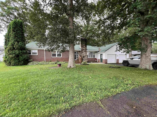 101 Wilson St, Elkins, WV 26241 - view of front facade with a chimney, a front yard, brick siding, and an attached garage