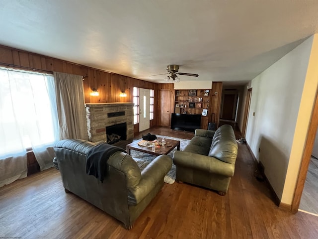 101 Wilson St, Elkins, WV 26241 - living room featuring wood finished floors, a ceiling fan, a fireplace, and wood walls