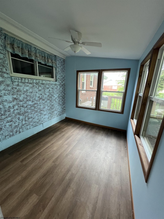 101 Wilson St, Elkins, WV 26241 - spare room featuring wood finished floors, a ceiling fan, and wallpapered walls
