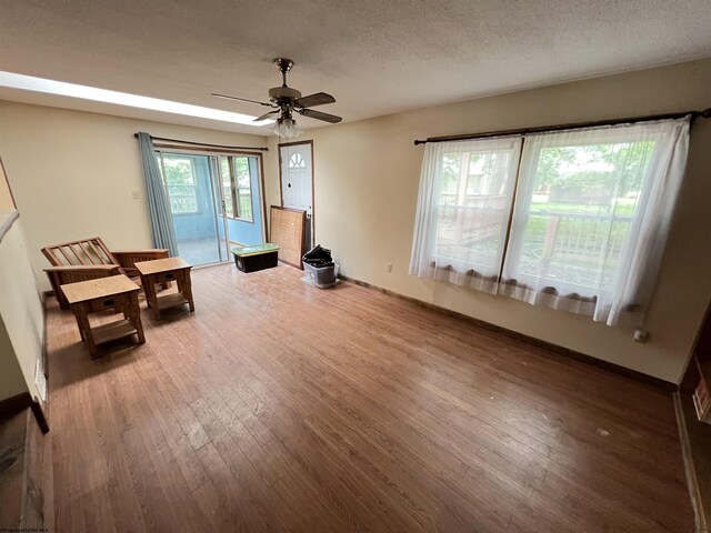 101 Wilson St, Elkins, WV 26241 - unfurnished living room featuring hardwood / wood-style floors, ceiling fan, and a textured ceiling