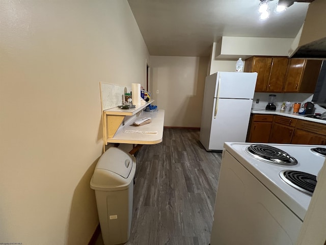101 Wilson St, Elkins, WV 26241 - kitchen with white appliances, premium range hood, dark wood finished floors, light countertops, and brown cabinets