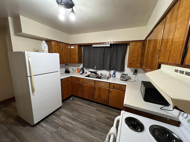 101 Wilson St, Elkins, WV 26241 - kitchen featuring white appliances, brown cabinets, light countertops, and dark wood-style flooring