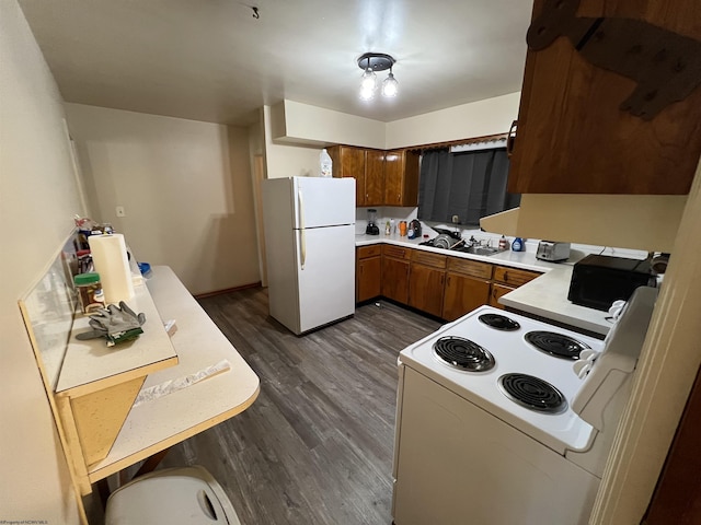 101 Wilson St, Elkins, WV 26241 - kitchen with white appliances, brown cabinets, dark wood-style flooring, and light countertops