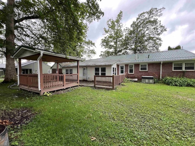 101 Wilson St, Elkins, WV 26241 - back of property featuring a wooden deck, a yard, brick siding, and a metal roof