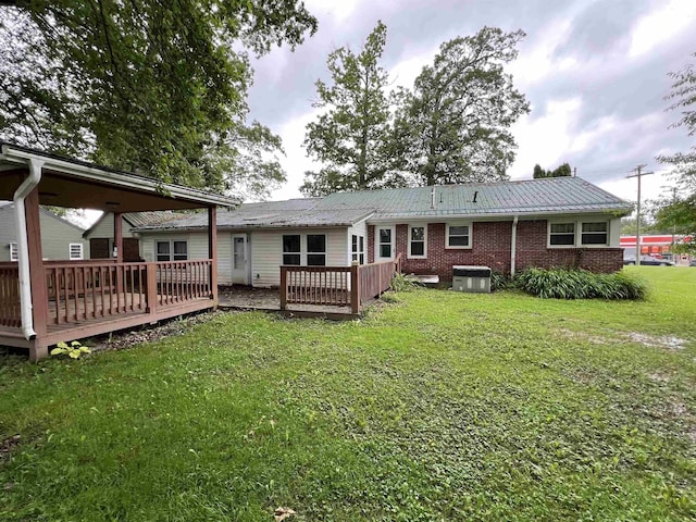 101 Wilson St, Elkins, WV 26241 - back of property with a deck, a yard, a metal roof, and brick siding