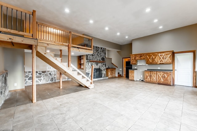 482 Buckeye Rd, Core, WV 26541 - unfurnished living room featuring recessed lighting, a stone fireplace, stairs, and light tile patterned floors