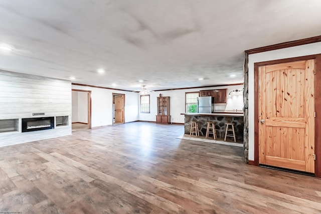 482 Buckeye Rd, Core, WV 26541 - unfurnished living room with ornamental molding, wood finished floors, a ceiling fan, recessed lighting, and a fireplace