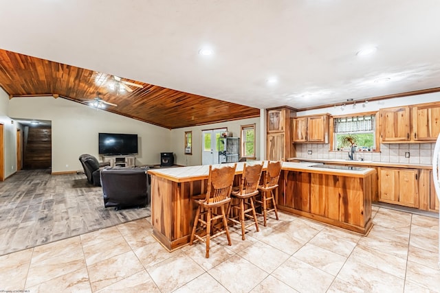 482 Buckeye Rd, Core, WV 26541 - kitchen with recessed lighting, tile countertops, decorative backsplash, vaulted ceiling, and a breakfast bar