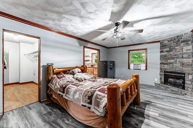 482 Buckeye Rd, Core, WV 26541 - bedroom with cooling unit, wood finished floors, ornamental molding, a fireplace, and ceiling fan