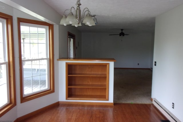 208 Parkview Cir, Kingwood, WV 26537 - unfurnished dining area featuring a chandelier, baseboard heating, wood finished floors, and a ceiling fan