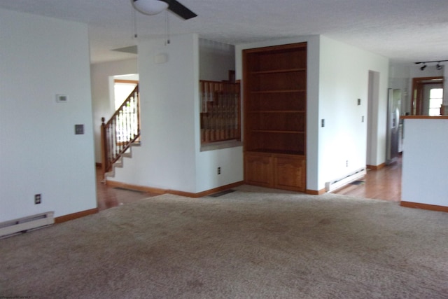 208 Parkview Cir, Kingwood, WV 26537 - unfurnished living room featuring carpet flooring, a baseboard radiator, ceiling fan, and stairs