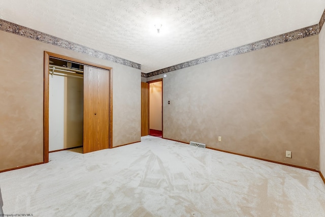 1005 Primrose Ln, Morgantown, WV 26505 - unfurnished bedroom with carpet floors, a textured ceiling, and a closet