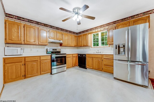 1005 Primrose Ln, Morgantown, WV 26505 - kitchen featuring appliances with stainless steel finishes, under cabinet range hood, light countertops, ceiling fan, and tasteful backsplash