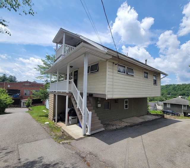 704 S Stewart St, Shinnston, WV 26431 - view of front of house with stairway, a balcony, and covered porch