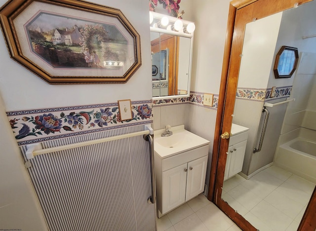 704 S Stewart St, Shinnston, WV 26431 - full bathroom with a wainscoted wall, vanity, tile patterned flooring, and a bath