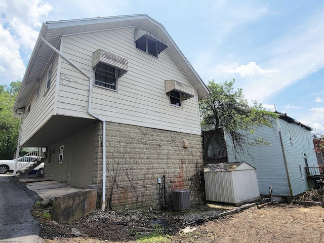 704 S Stewart St, Shinnston, WV 26431 - view of side of home featuring a storage unit and a cooling unit