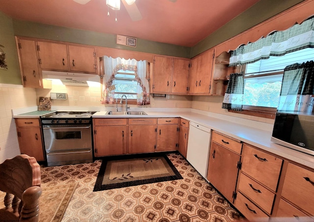 704 S Stewart St, Shinnston, WV 26431 - kitchen with range, under cabinet range hood, white dishwasher, stainless steel microwave, and light countertops