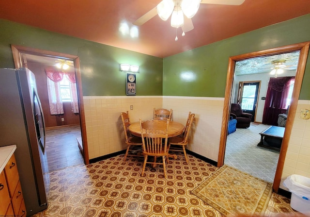 704 S Stewart St, Shinnston, WV 26431 - dining space featuring ceiling fan, wainscoting, and tile walls