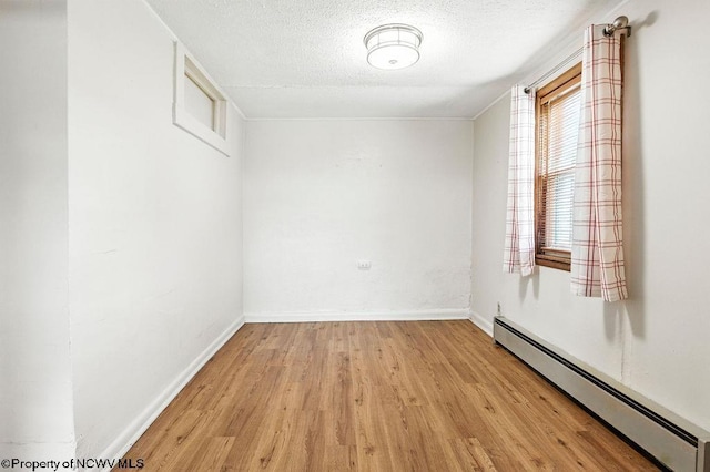 2300 Pride Ave, Clarksburg, WV 26301 - spare room with a baseboard heating unit, light wood finished floors, and a textured ceiling