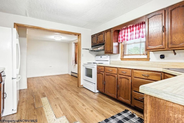 2300 Pride Ave, Clarksburg, WV 26301 - kitchen with white appliances, under cabinet range hood, light countertops, light wood-style floors, and a textured ceiling