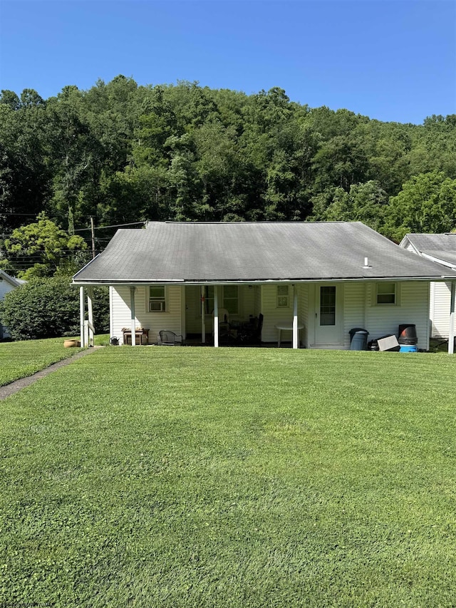 506 Broad St, Weston, WV 26452 - view of front of property featuring a front lawn, an attached carport, and a wooded view