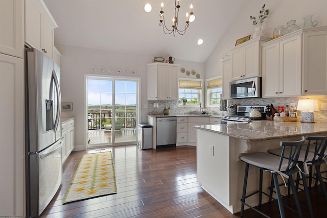 211 Berkshire Cir, Bridgeport, WV 26330 - kitchen featuring stainless steel appliances, a peninsula, tasteful backsplash, white cabinets, and dark wood finished floors