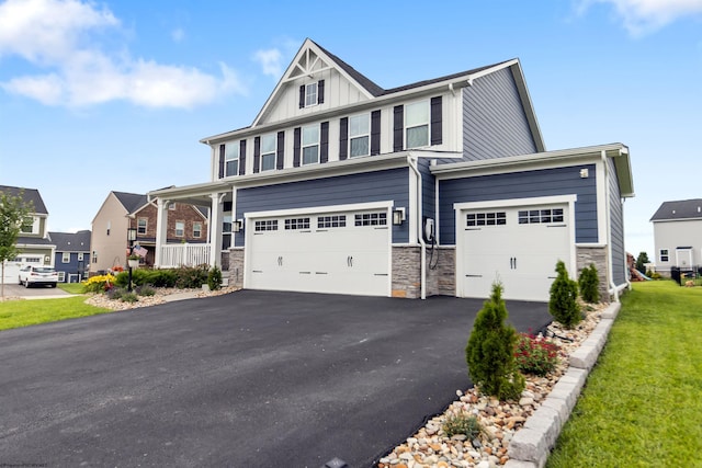 204 Falling Water Ln, Morgantown, WV 26508 - craftsman house with board and batten siding, an attached garage, asphalt driveway, stone siding, and a front lawn
