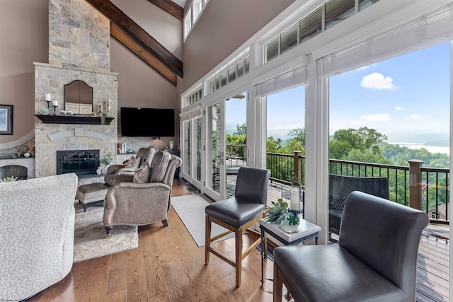 1009 Summit Dr, Morgantown, WV 26508 - living area featuring beam ceiling, a fireplace, high vaulted ceiling, wood finished floors, and plenty of natural light