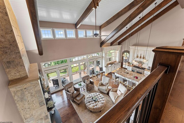1009 Summit Dr, Morgantown, WV 26508 - living area with high vaulted ceiling, a ceiling fan, beam ceiling, and wood finished floors