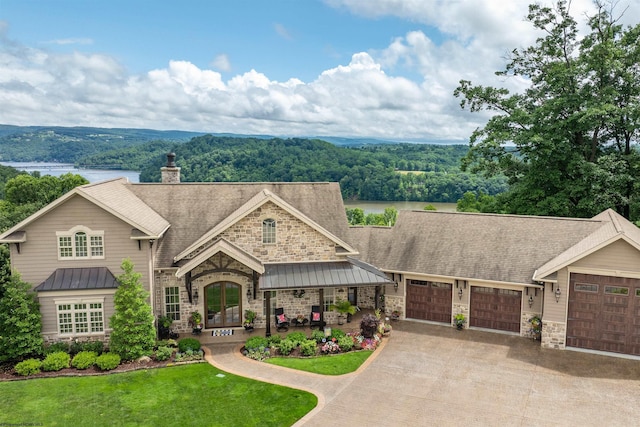 1009 Summit Dr, Morgantown, WV 26508 - view of front of home featuring stone siding, a standing seam roof, driveway, and a view of trees
