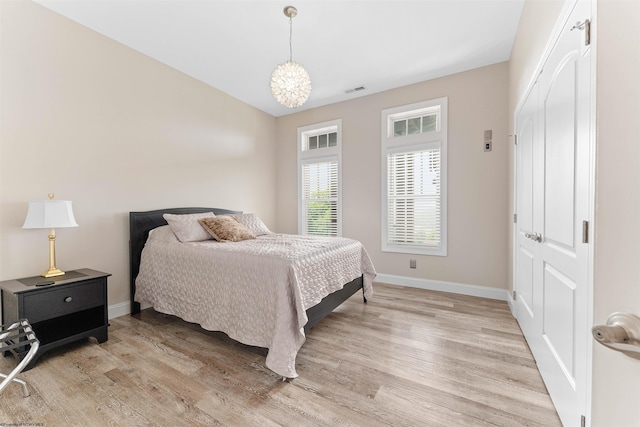 1009 Summit Dr, Morgantown, WV 26508 - bedroom with light wood finished floors, a closet, and a chandelier