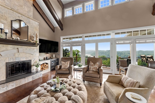 1009 Summit Dr, Morgantown, WV 26508 - living room featuring a high ceiling, wood finished floors, a fireplace, and beam ceiling