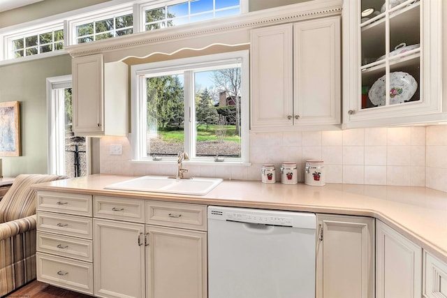 1348 Anderson Ave, Morgantown, WV 26505 - kitchen with white dishwasher, light countertops, tasteful backsplash, and glass insert cabinets
