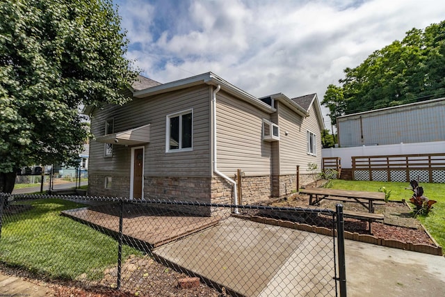 42 Crummitt Ln, Clarksburg, WV 26301 - view of property exterior featuring stone siding, a patio area, and a gate