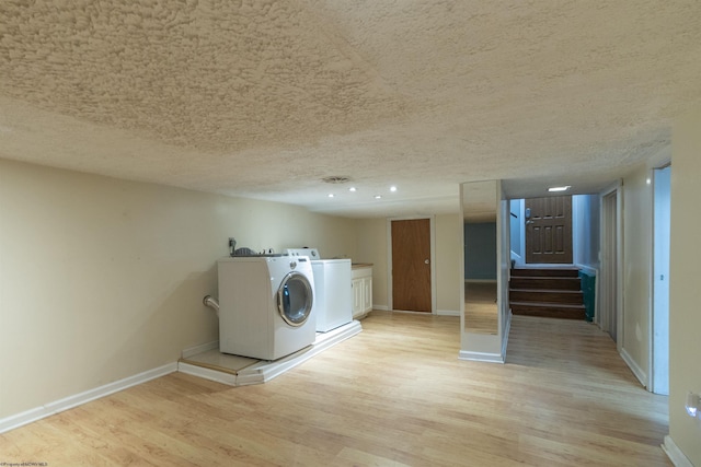 42 Crummitt Ln, Clarksburg, WV 26301 - laundry area with cabinet space, light wood-style floors, a textured ceiling, and washer and clothes dryer