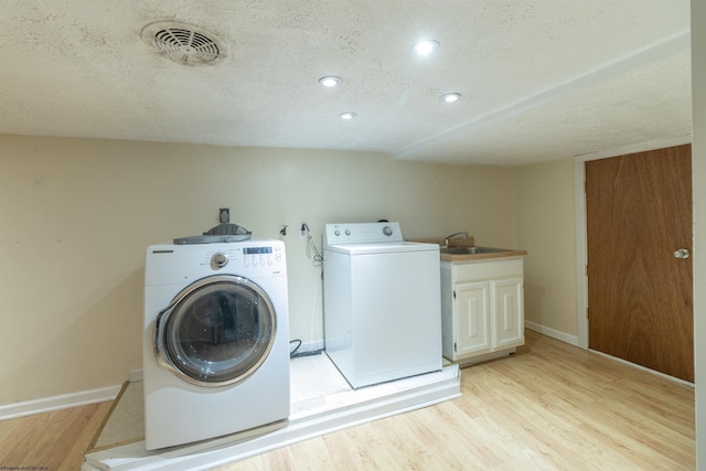 42 Crummitt Ln, Clarksburg, WV 26301 - laundry area featuring washing machine and dryer, light wood-type flooring, cabinet space, a textured ceiling, and recessed lighting
