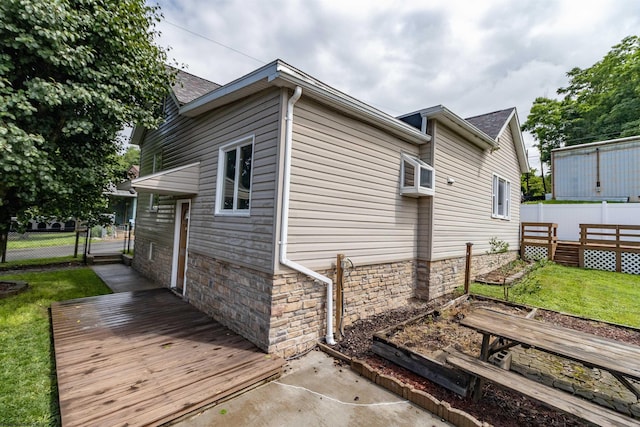 42 Crummitt Ln, Clarksburg, WV 26301 - view of side of home with a deck, stone siding, a gate, and a garden