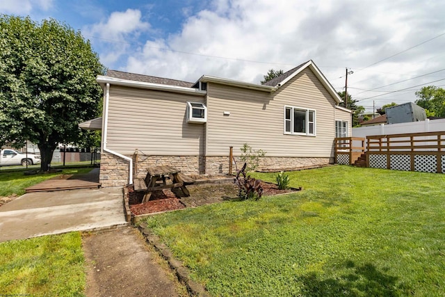 42 Crummitt Ln, Clarksburg, WV 26301 - rear view of property featuring a lawn, stone siding, and a deck