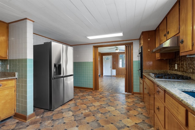42 Crummitt Ln, Clarksburg, WV 26301 - kitchen featuring stainless steel appliances, under cabinet range hood, brown cabinets, dark floors, and a ceiling fan