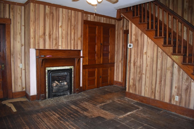 132 Racine St, Morgantown, WV 26505 - unfurnished living room with wood-type flooring, stairs, ceiling fan, a fireplace, and wooden walls