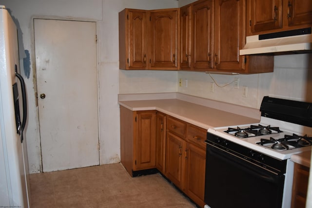 132 Racine St, Morgantown, WV 26505 - kitchen with white appliances, under cabinet range hood, light countertops, and brown cabinets