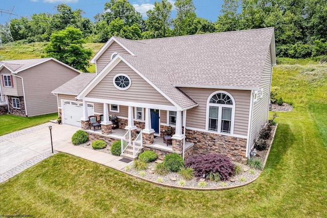 117 Summits Rdg, Morgantown, WV 26508 - view of front facade with concrete driveway, a garage, a porch, a front yard, and stone siding