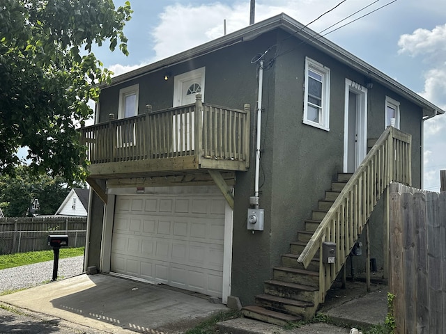 1218 N 18th St, Clarksburg, WV 26301 - view of front of property with stucco siding, an attached garage, and a balcony
