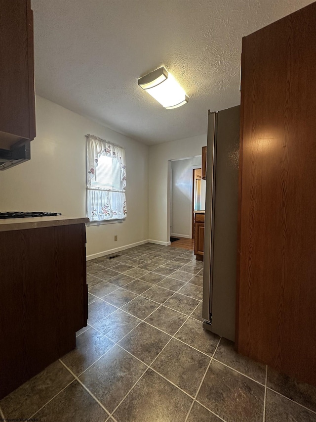 1218 N 18th St, Clarksburg, WV 26301 - empty room with dark tile patterned floors and a textured ceiling