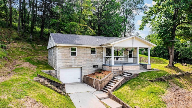 552 White Ave, Morgantown, WV 26501 - ranch-style house with stone siding, a garage, covered porch, concrete driveway, and a front lawn