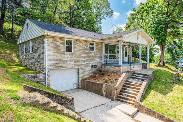 552 White Ave, Morgantown, WV 26501 - ranch-style house with stone siding, concrete driveway, an attached garage, covered porch, and a front yard