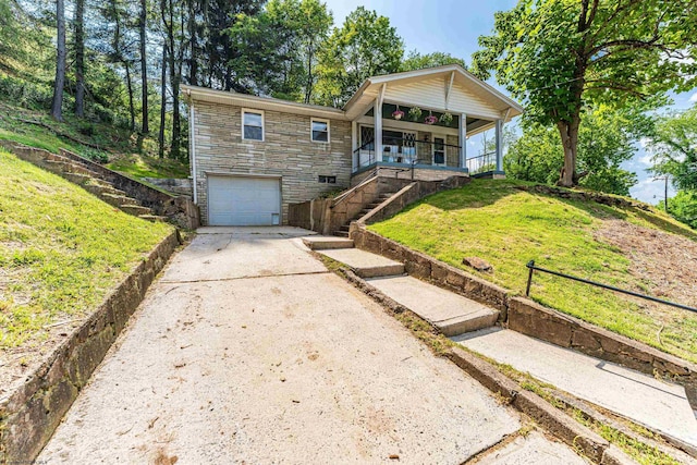 552 White Ave, Morgantown, WV 26501 - view of front of property with concrete driveway, an attached garage, a porch, stone siding, and a front lawn